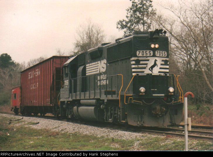 NS 7055 leads a very short "model railroad sized" train with the bare mininums to be called a train in the caboose era of the early 1990s